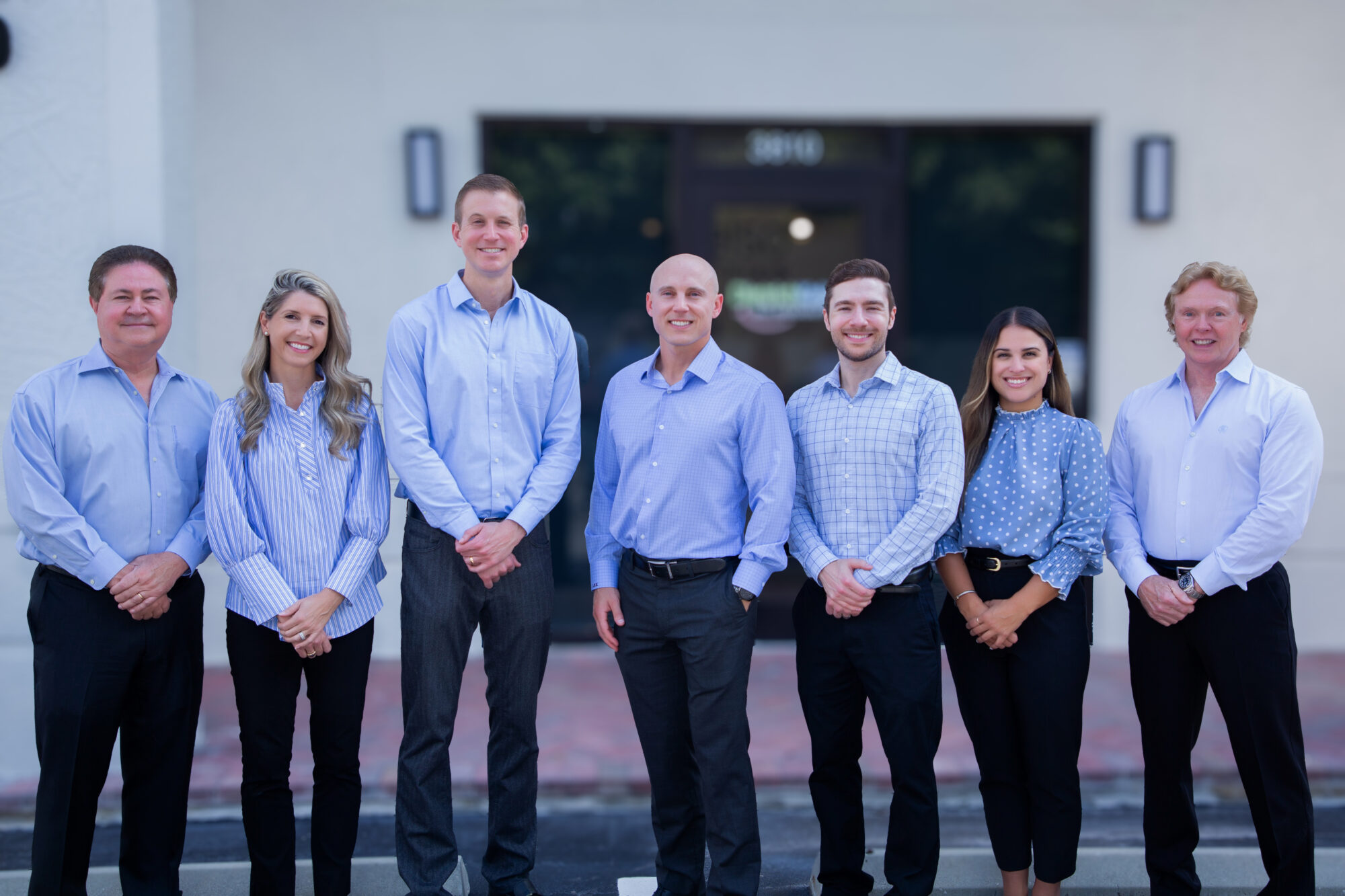 doctors smiling in front of lake